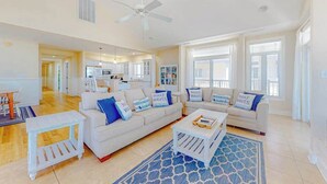 A spacious living room with a white sofa set, a coffee table, and a blue patterned rug. - Key Largo Penthouse w/ Ocean View, W/D, WiFi, AC - Half a Block to the Beach (Ocean City)