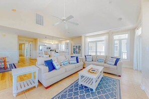 A spacious living room with a white sofa set, a coffee table, and a blue patterned rug. - Key Largo Penthouse w/ Ocean View, W/D, WiFi, AC - Half a Block to the Beach (Ocean City)