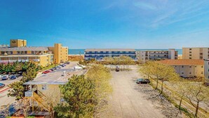 A coastal hotel with multiple buildings, a parking lot, and a clear view of the ocean. - Key Largo Penthouse w/ Ocean View, W/D, WiFi, AC - Half a Block to the Beach (Ocean City)