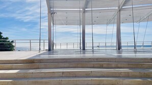 A covered outdoor area with steps leading to a railing overlooking a body of water. - Apartamento Faro 77 by At Home Costa del Sol (Torrox)