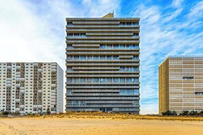 A multi-story building with a modern architectural design, featuring horizontal lines and a flat roof. - Oceanfront Getaway w/ Private Balcony, Free WiFi, Beach Access & Shared Pool (Ocean City)