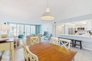 A modern kitchen with white cabinets, a microwave, and a large window. - 16th-floor ocean-view condo with game room, in/outdoor pools, tennis, saunas, AC (Ocean City)