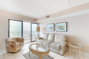 A living room with a sofa, armchair, and two small tables. - Sixth-floor oceanfront condo w/central AC, washer/dryer, furnished balcony (Ocean City)