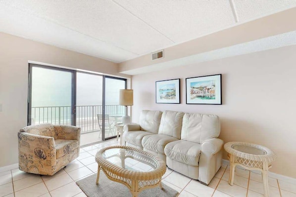 A living room with a sofa, armchair, and two small tables. - Sixth-floor oceanfront condo w/central AC, washer/dryer, furnished balcony (Ocean City)
