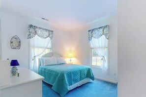 A bedroom with a bed, a nightstand, a lamp, a mirror, and two windows with curtains. - Family-Friendly Home Close to OC w/Furnished Porch, Central A/C, & Free WiFi (Berlin)