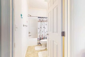 A bathroom with a bathtub, toilet, and shower curtain. - Family-Friendly Home Close to OC w/Furnished Porch, Central A/C, & Free WiFi (Berlin)