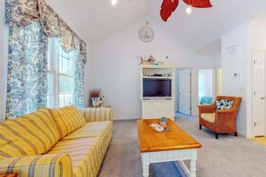 A living room with a sofa, a coffee table, a television, and a chair. - Family-Friendly Home Close to OC w/Furnished Porch, Central A/C, & Free WiFi (Berlin)