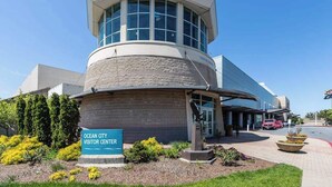 A building with a curved facade, a prominent tower with large windows, and a sign reading 'Ocean City Visitor Center'. - Homey, comfortable condo w/ a furnished balcony - just blocks from the beach (Ocean City)