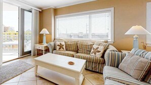A living room with a sofa, a coffee table, and two lamps.