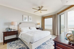 A bedroom with a large bed, bedside tables, a ceiling fan, and a view of the ocean. - Gateway Grand 410 (Ocean City)