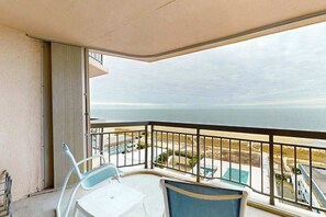 A balcony with a view of the ocean, a table, and two chairs. - Fountainhead Towers 1001 (Ocean City)