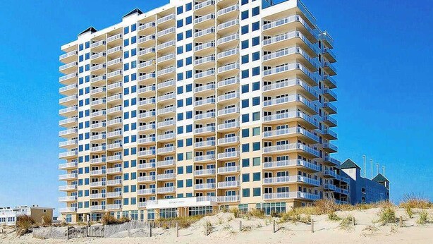A multi-story hotel with balconies, located near a beach. - Gateway Grand 507 (Ocean City)