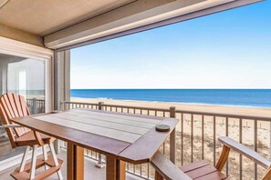 Outdoor dining - Oceanfront Pelican Beach condo with sunrise ocean views, AC, laundry & WiFi (Ocean City)