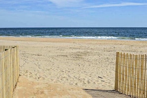 A beach with a wooden fence and a drain channel. - Boca Grande 504 (Ocean City)
