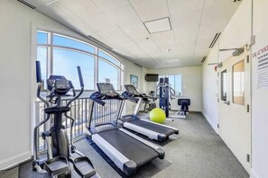 A gym with treadmills, elliptical machines, and a stationary bike. - South Beach 703 (Ocean City)