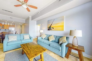 A living room with a sofa, coffee table, and lamps. - South Beach 703 (Ocean City)