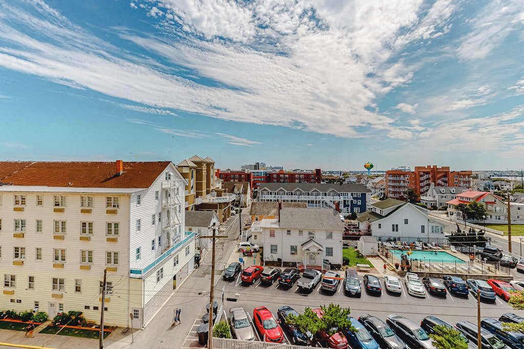 Ein mehrgeschossiges Gebäude mit Parkplatz davor.