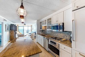 Fridge, microwave, oven, stovetop - Oceanfront condo with stunning view, large balcony, AC, WiFi & shared pool (Ocean City)