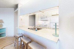 Fridge, microwave, oven, stovetop - Oceanfront Condo with Covered Balcony, WiFi, AC, Laundry & Shared Pool (Ocean City)