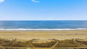 Ein Strand mit einem eingezäunten Bereich und freiem Blick auf das Meer.