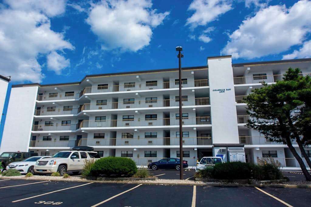 A multi-story hotel with a parking lot in front, labeled 'Oceanwalk East.'