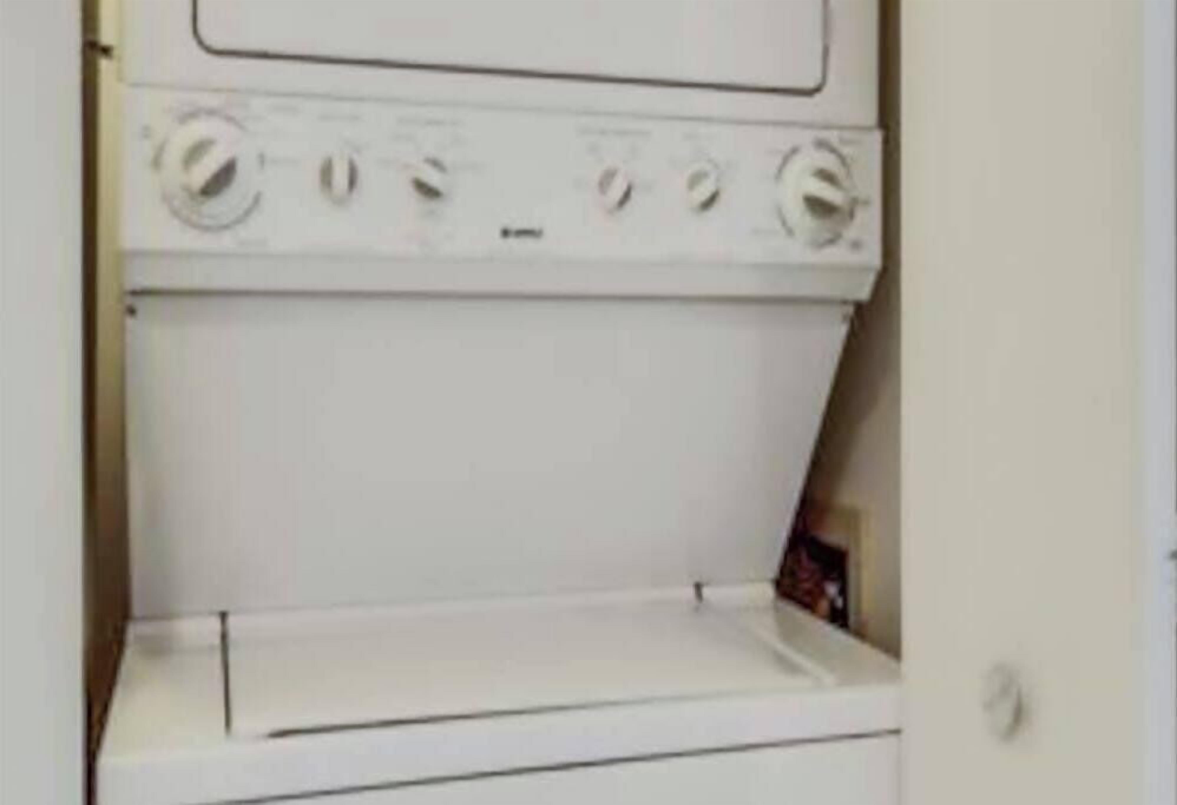 A white washing machine in a utility room.