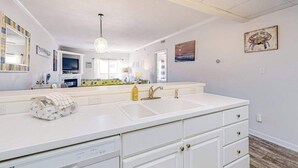 A modern bathroom with a double sink, white cabinetry, and a large mirror. - Newly Updated Condo Steps from the Beach w/ Balcony, Shared Rooftop Pool (Ocean City)