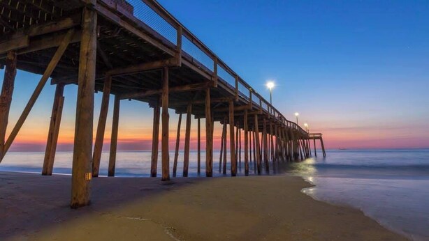 A wooden pier extending into calm waters at dusk. - Casa Sophia #12 (Ocean City)