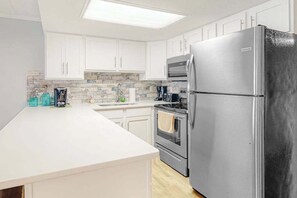 Fridge, microwave, oven, stovetop - Side Ocean View Condo near the Boardwalk with Balcony, AC, WiFi & Shared Pool (Ocean City)