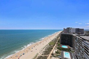 A beachfront hotel with a pool, beach access, and ocean views. - Light-filled beach condo with balcony, W/D, pools, gym, sauna & AC (Ocean City)