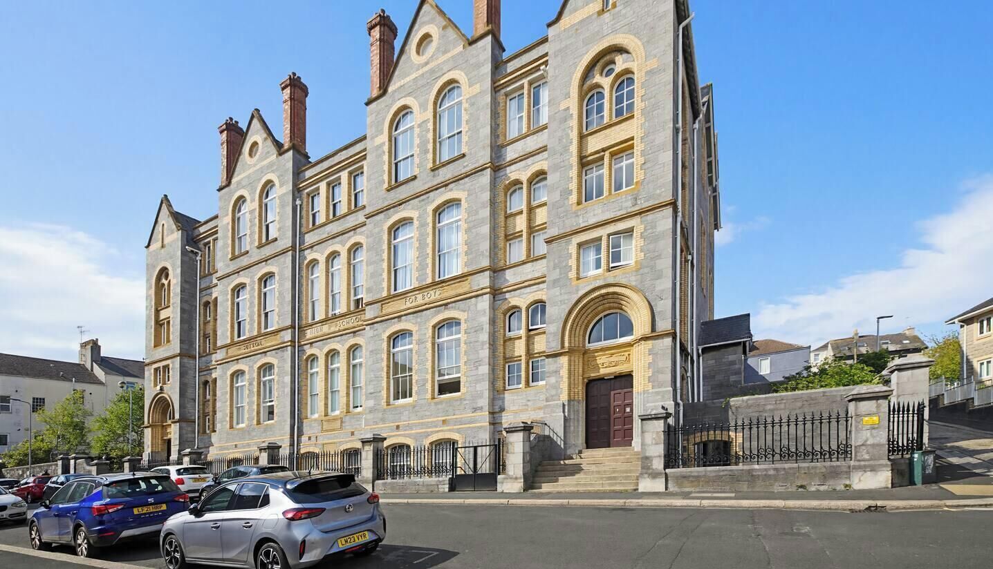 A historic building with multiple windows and a prominent entrance.