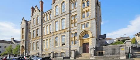 A historic building with multiple windows and a prominent entrance.