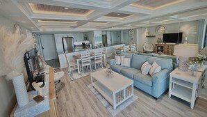 Ein geräumiger Wohnbereich mit Sofa, Couchtisch und Esstisch.