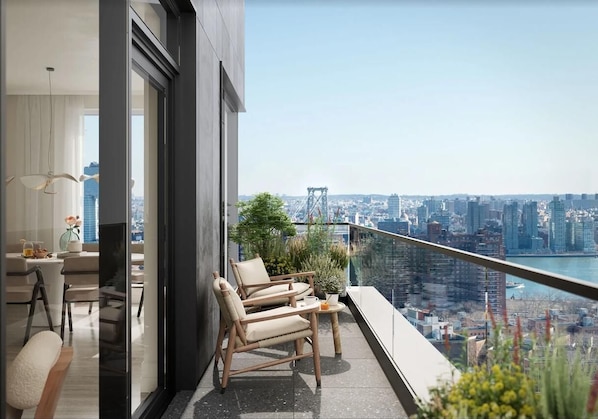 A balcony with a city view, a dining area with a table and chairs, and a potted plant.