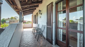 A covered outdoor area with a tiled floor, a pergola, and a seating arrangement. - Ca' Felicina - Two Bedroom Apartment, Sleeps 4 (Alba)