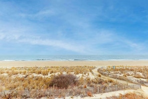 A beach with a wooden fence and dry vegetation. - Oceanfront Condo w/ Balcony, Ocean View, Central AC, W/D & Beach Access (Ocean City)