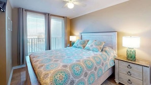 A bedroom with a bed, nightstands, a ceiling fan, and a window with blinds. - Polynesian 309 (Ocean City)