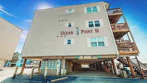 A multi-story building with 'Ocean Point II' signage, a covered entrance, and a wooden staircase on the right. - Well-Equipped Beach Condo near the Ocean w/Private Balcony, Central A/C, W/D (Ocean City)