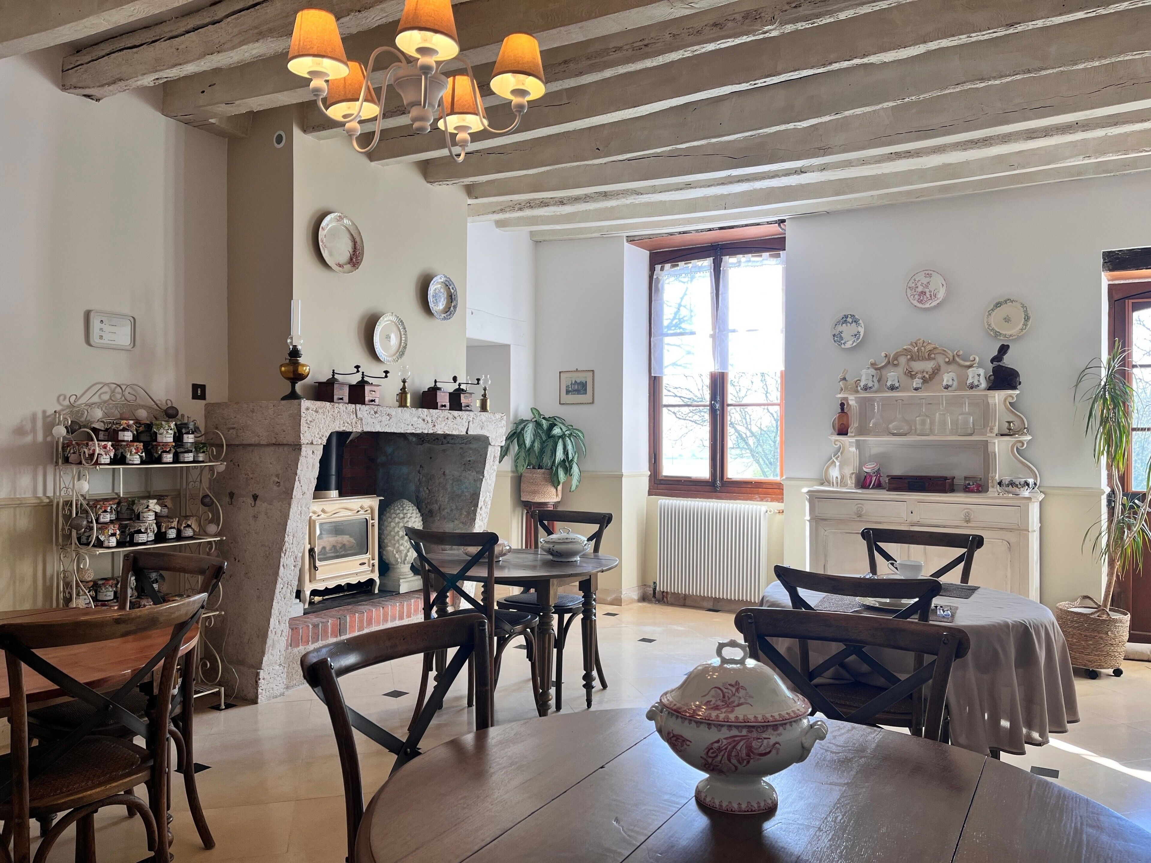 A rustic room with a fireplace, wooden furniture, and decorative plates on the walls.