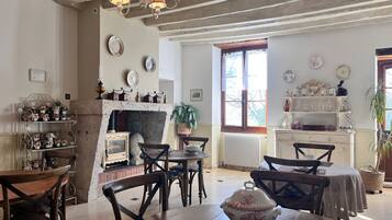 A rustic room with a fireplace, wooden furniture, and decorative plates on the walls.