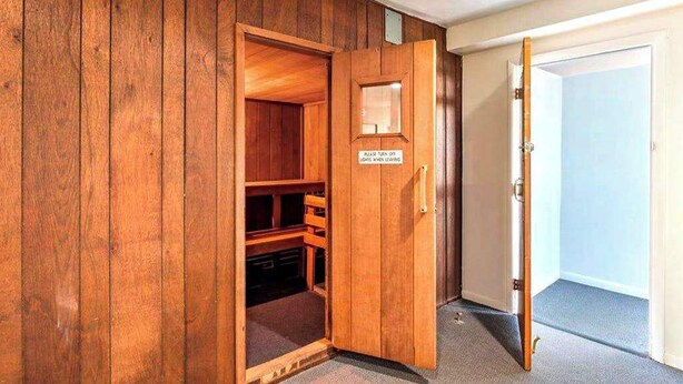 A wooden door with a sign instructing to turn off lights when leaving. - Affordable studio with great beach views, pools & grills (Ocean City)