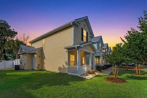 A two-story house with a porch, a small front yard, and a tree. - Gulf Stream Cottages 1928-walk to beach (Myrtle Beach)