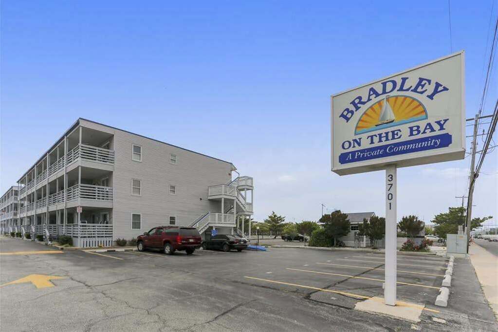 A multi-story building with a sign reading 'Bradley on the Bay' and a private community designation.