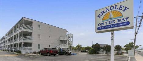 A multi-story building with a sign reading 'Bradley on the Bay' and a private community designation.