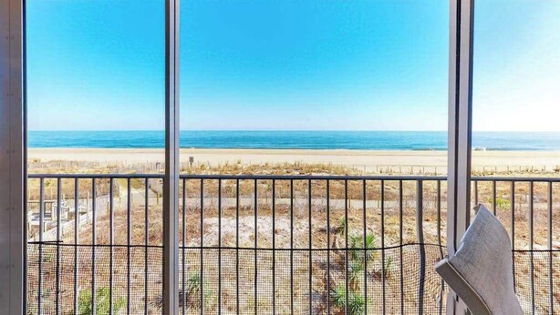 A balcony with a view of the beach and ocean. - English Towers 205 (Ocean City)