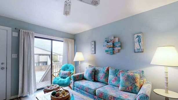 A living room with a sofa, a chair, a coffee table, and a lamp. - Club Ocean Villa II 97 (Ocean City)