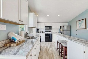 Fridge, microwave, oven, stovetop - Canal-Front Home w/Deck, Washer/Dryer, Free WiFi, Outdoor Dining Area, & More (Ocean City)