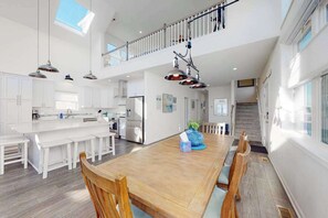 A spacious kitchen with white cabinetry, a large island, and pendant lighting. - Atlantic Blvd 13314 (Ocean City)