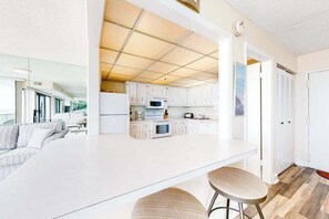 Fridge, microwave, oven, stovetop - Bright coastal condo with pool access, side views of the ocean, balcony & W/D (Ocean City)