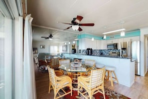 A modern kitchen with a central island, white cabinetry, and stainless steel appliances. - Terrific Suite in Bayfront Complex w/Shared Pool, Free WiFi, Central AC, Balcony (Ocean City)